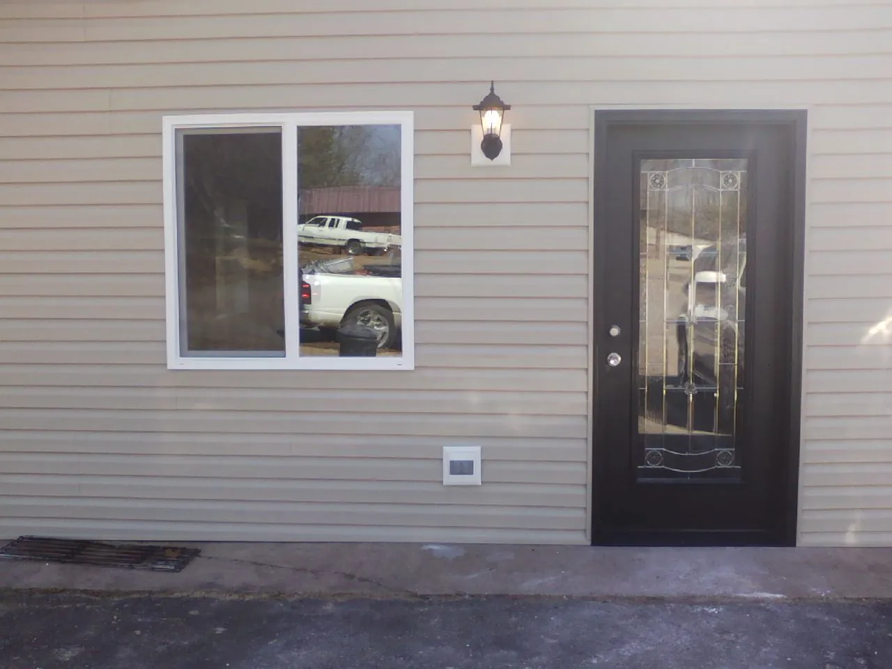 New siding, window and entry door on the side of an addition in Verona
